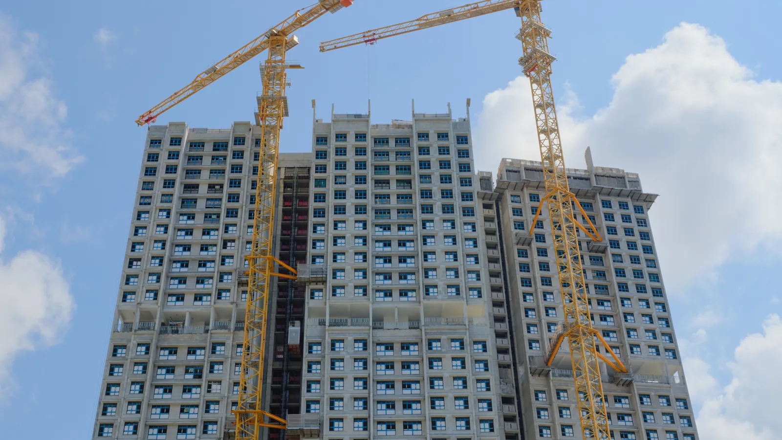 Proyek konstruksi bertingkat pada sore hari, salah satu bentuk kehadiran yang paling sering memicu status bentuk usaha tetap.